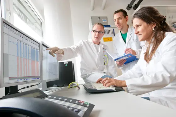Die Heidelberger Krebsforscher Prof. Barbara Burwinkel, Dr. Harald Surowy und Dr. Andrey Turchinovich werten DNA-Sequenzen am Rechner aus.