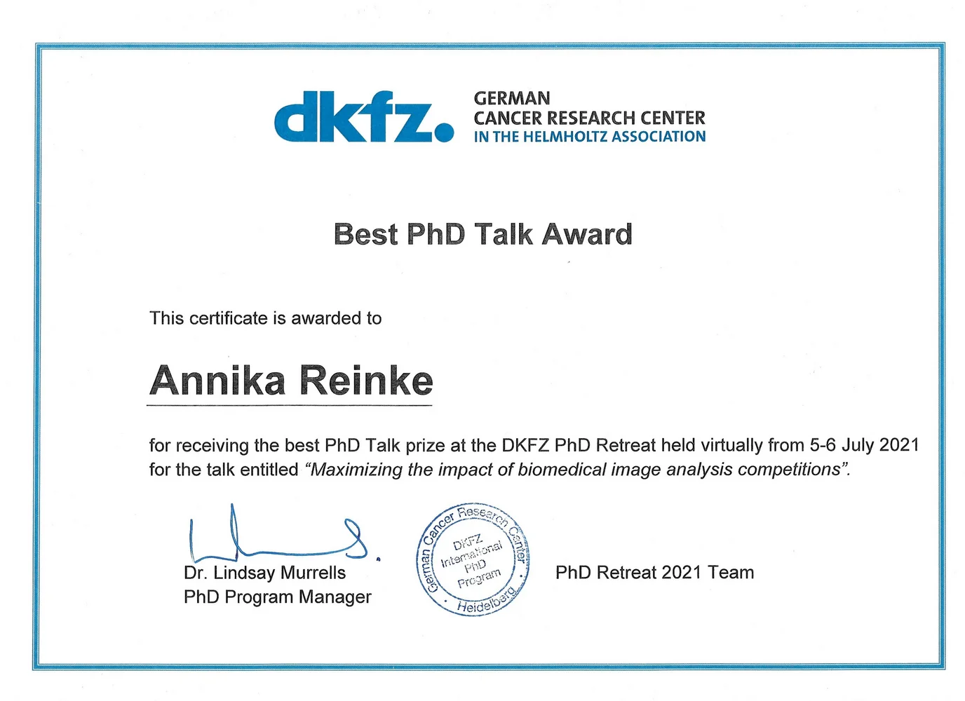 Certificate awarding the "Best PhD Talk" to Annika Reinke for her presentation titled "Maximizing the impact of biomedical image analysis competitions" at the DKFZ PhD Retreat held virtually from July 5-6, 2021. Signed by Dr. Lindsay Murrells, PhD Program Manager.