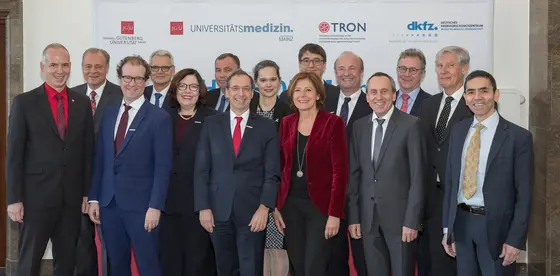 v. l. n. r., vorne: Georg Krausch, Gutenberg Universität Mainz, Christian Elsner, Universitätsmedizin (UM) Mainz, Marion Hahn, UM Mainz, Norbert Pfeiffer, UM Mainz, Ministerpräsidentin Malu Dreyer, Konrad Wolf, Wissenschaftsminister Rheinland-Pfalz, Ugur Sahin, TRON. Hinten: Michael Föhlings, TRON, Dirk Heinz, Helmholtz, Josef Puchta, DKFZ, Veronika von Messling, BMBF, Michael Baumann, DKFZ, Ulrich Förstermann, UM Mainz, Stephan Grabbe, UM Mainz, Christoph Huber, ehem. UM Mainz