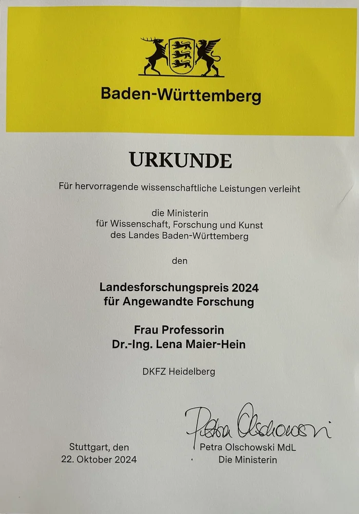 A certificate awarding the Landesforschungspreis 2024 for applied research to Dr.-Ing. Lena Maier-Hein from the Minister of Science, Research, and the Arts of Baden-Württemberg. It includes the date, "22. Oktober 2024," and is signed by Petra Olschowski, the Minister.