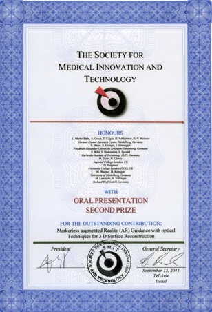 A certificate awarded by The Society for Medical Innovation and Technology, recognizing a second prize for an oral presentation titled "Markerless Augmented Reality (AR) Guidance with Optical Techniques for 3D Surface Reconstruction," dated September 15, 2011. It features a decorative border and the organization's logo.