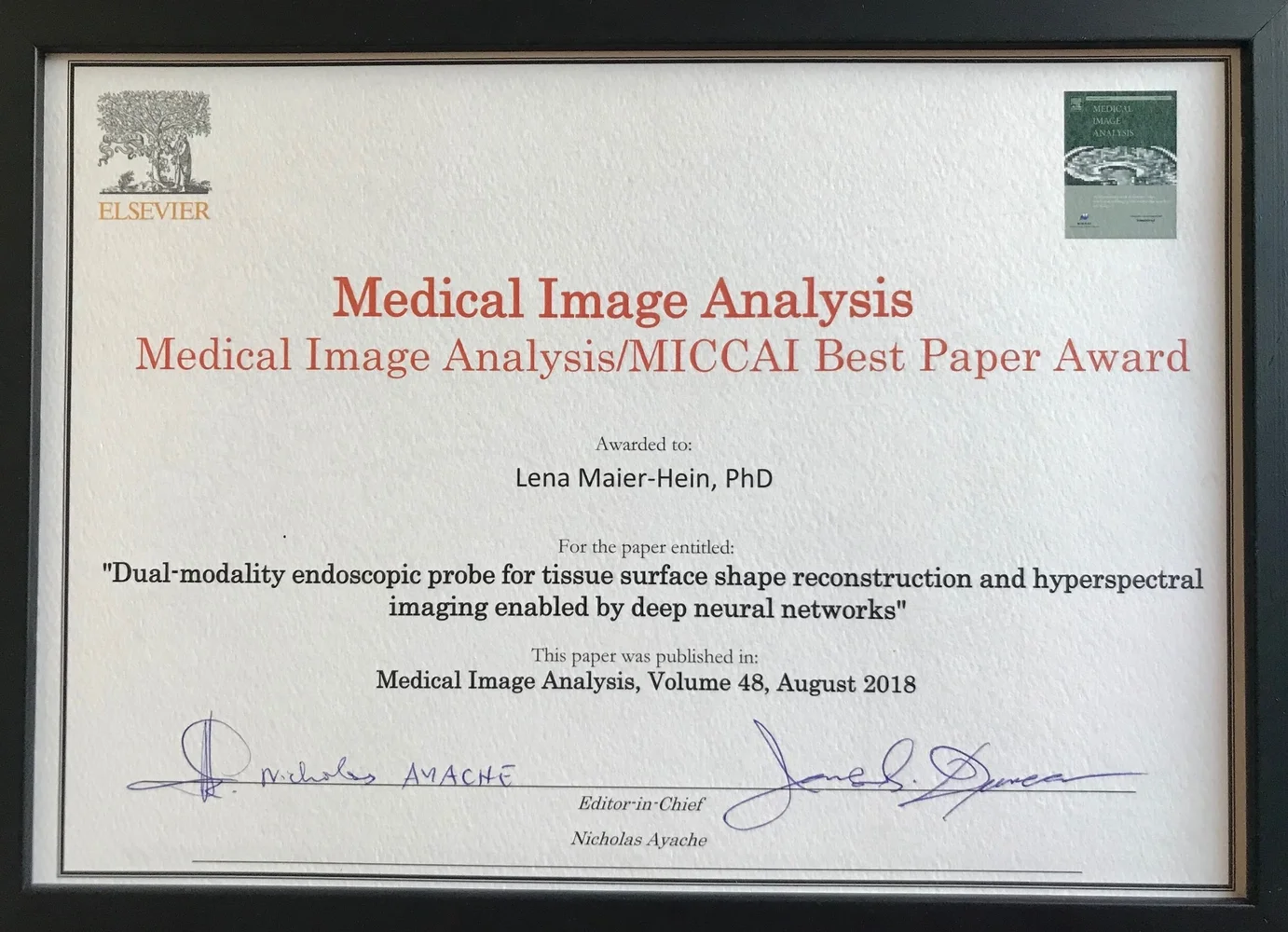 A certificate awarded to Lena Maier-Hein, PhD, for the Best Paper at the Medical Image Analysis/MICCAI conference. The paper is titled "Dual-modality endoscopic probe for tissue surface shape reconstruction and hyperspectral imaging enabled by deep neural networks," published in Medical Image Analysis, Volume 48, August 2018.