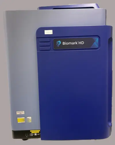 A laboratory device labeled "Biomark HD" in blue is shown. The unit is predominantly gray with blue accents and features a control panel on the front. It is designed for scientific or medical applications, showcasing a compact and modern design.