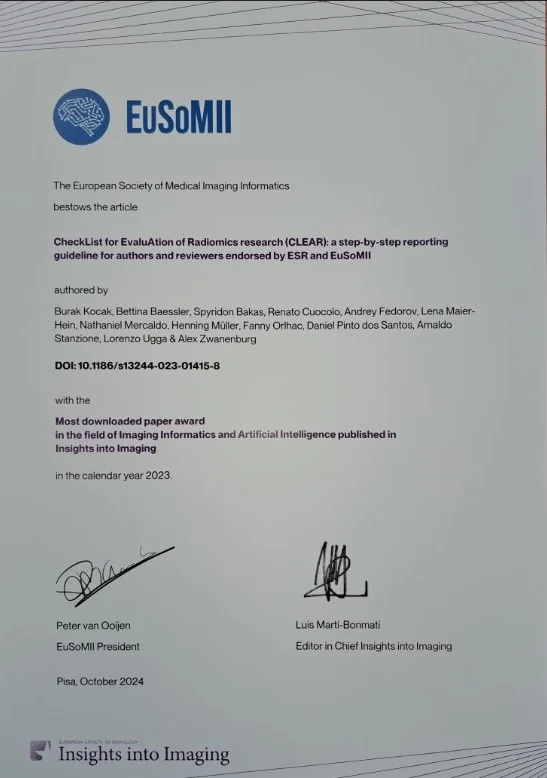 Certificate from the European Society of Medical Imaging Informatics (EuSoMII) recognizing the "CheckList for Evaluation of Radiomics research (CLEAR)" article, authored by multiple contributors. It also states the article received the award for the most downloaded paper in 2023 in the field of Imaging Informatics.