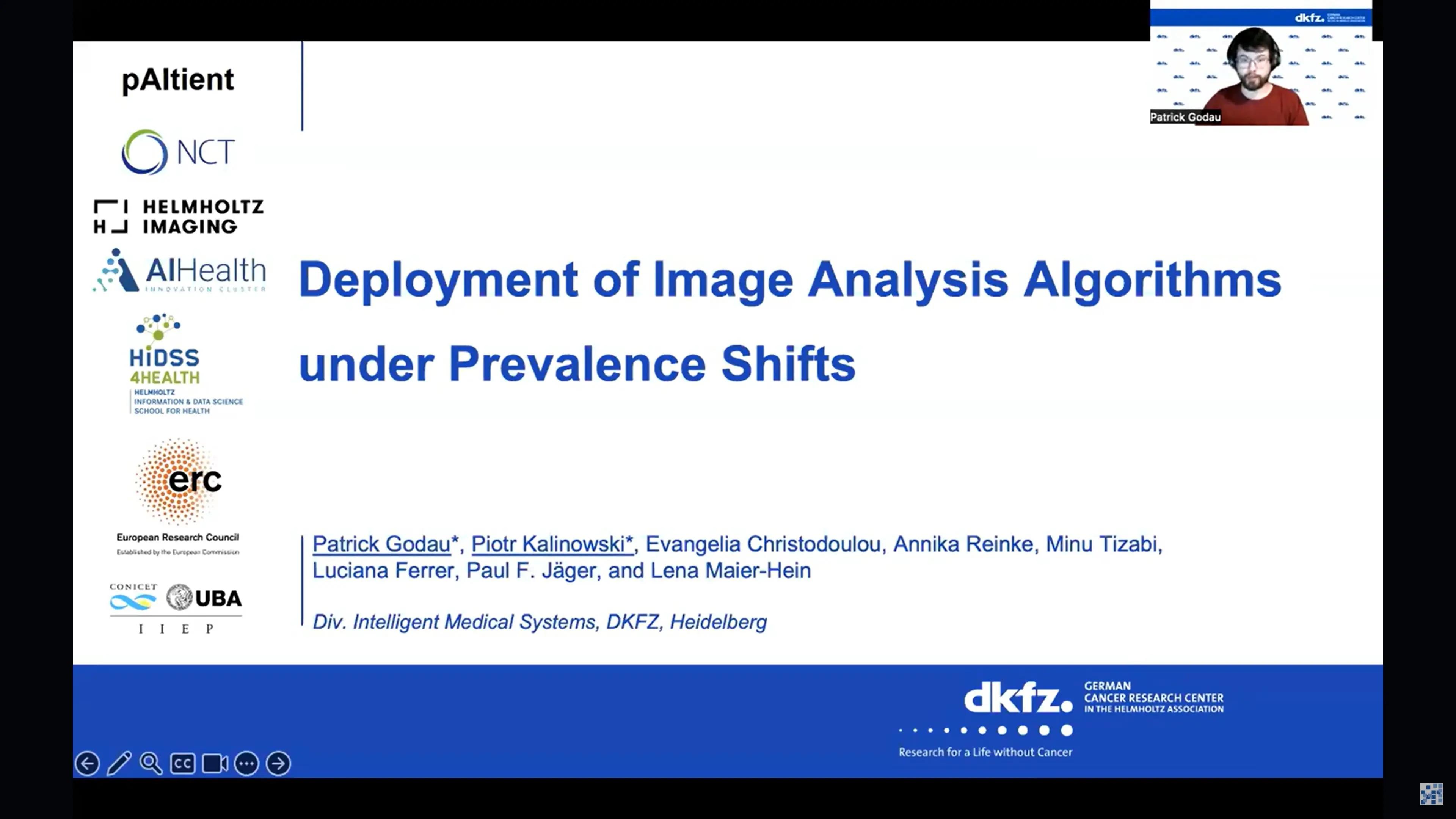 The image features a presentation slide titled "Deployment of Image Analysis Algorithms under Prevalence Shifts." It includes the names of the authors and organizations involved, along with a logo for the DKFZ. A person is visible in the top corner, likely presenting the slide.