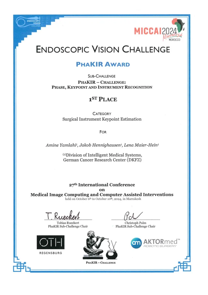 Certificate for the Phakir Award, awarded for first place in the Endoscopic Vision Challenge for Surgical Instrument Keypoint Estimation. It recognizes contributions from Amine Yamlıha, Jakob Hennighausen, and Lena Maier-Heiri from the German Cancer Research Center, at the MICCAI 2024 conference.